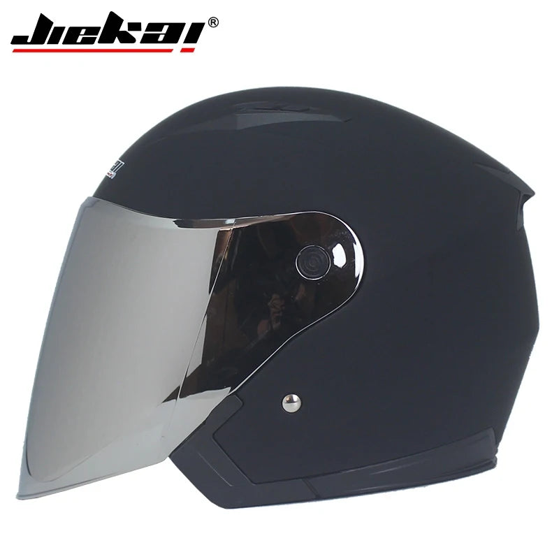 Black matte motorcycle half helmet with a dual lens. This Duckai brand helmet features a sleek, modern design suitable for riding scooters, motorcycles, or motocross bikes. The helmet has a protective shell and a clear face shield to provide visibility and wind protection during outdoor rides.