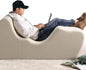 Foam recliner chair with user using laptop, offering ergonomic positioning for better relaxation, pillow included for enhanced comfort