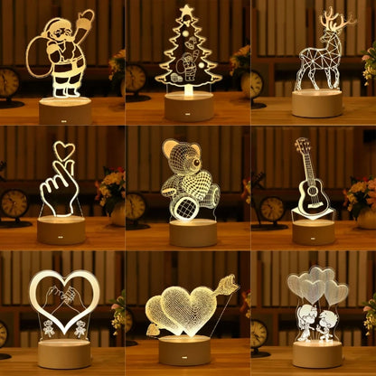 Romantic 3D LED lamps featuring various holiday and love-themed designs, including Santa, Christmas tree, deer, heart, teddy bear, guitar, and couples, displayed on wooden shelves.