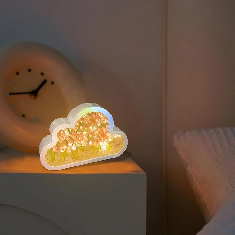 Whimsical cloud-shaped LED night light with a warm, glowing amber display, creating a cozy bedroom ambiance with its decorative mirror table design.