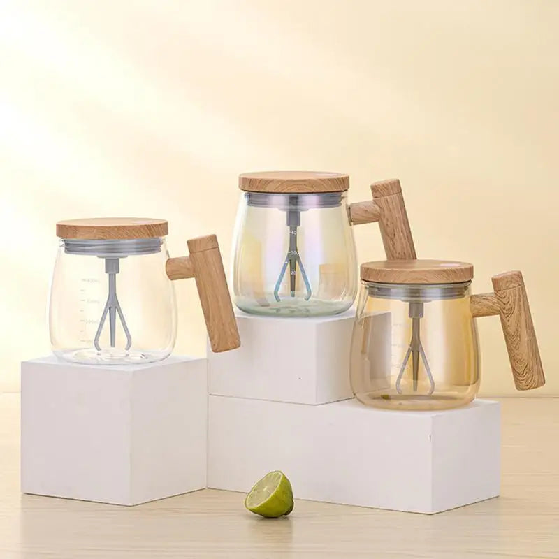 Glass and wood electric self-stirring coffee mugs and cups on white cubes against a light background