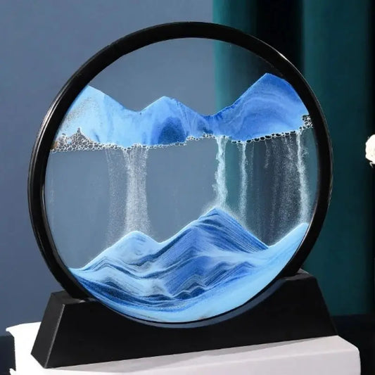 Mesmerizing 3D sand art glass display with flowing blue mountainscape and waterfall design, showcasing a serene and captivating natural landscape scene.