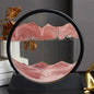 Decorative round glass sculpture with swirling pink sand creating a mesmerizing desert landscape, surrounded by black frame, creating a captivating office or home decor piece.
