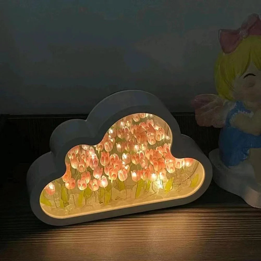 Decorative cloud-shaped LED night light with a warm, whimsical design featuring colorful tulip-like patterns on a dark background, creating a cozy ambiance for a bedroom or home decor.