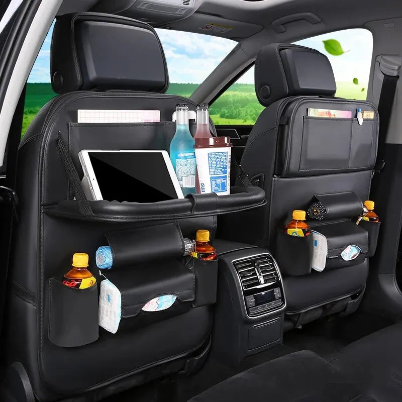 Functional car seat back organizer and storage system with foldable table tray, multiple pockets, and drink holders for convenient in-car organization.