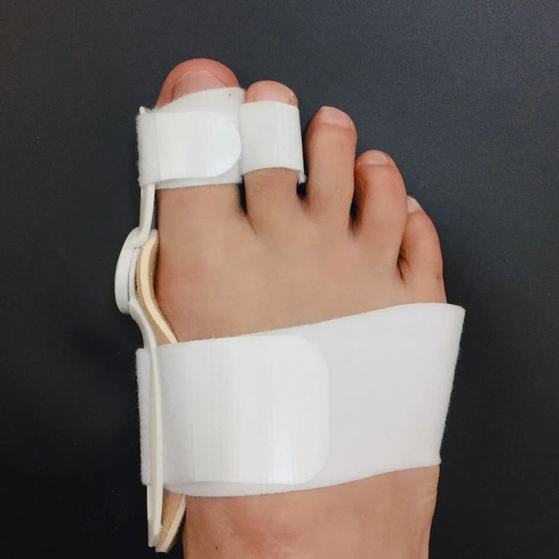 White bunion splint straightener and corrector on foot for pain relief and foot care