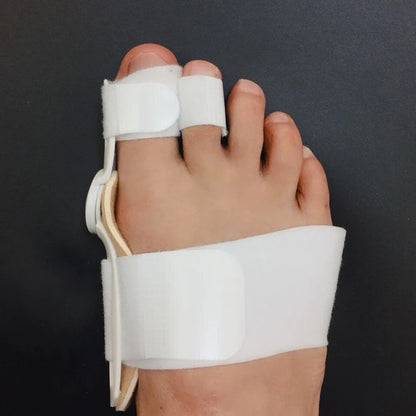 White bunion splint straightener and corrector on foot for pain relief and foot care