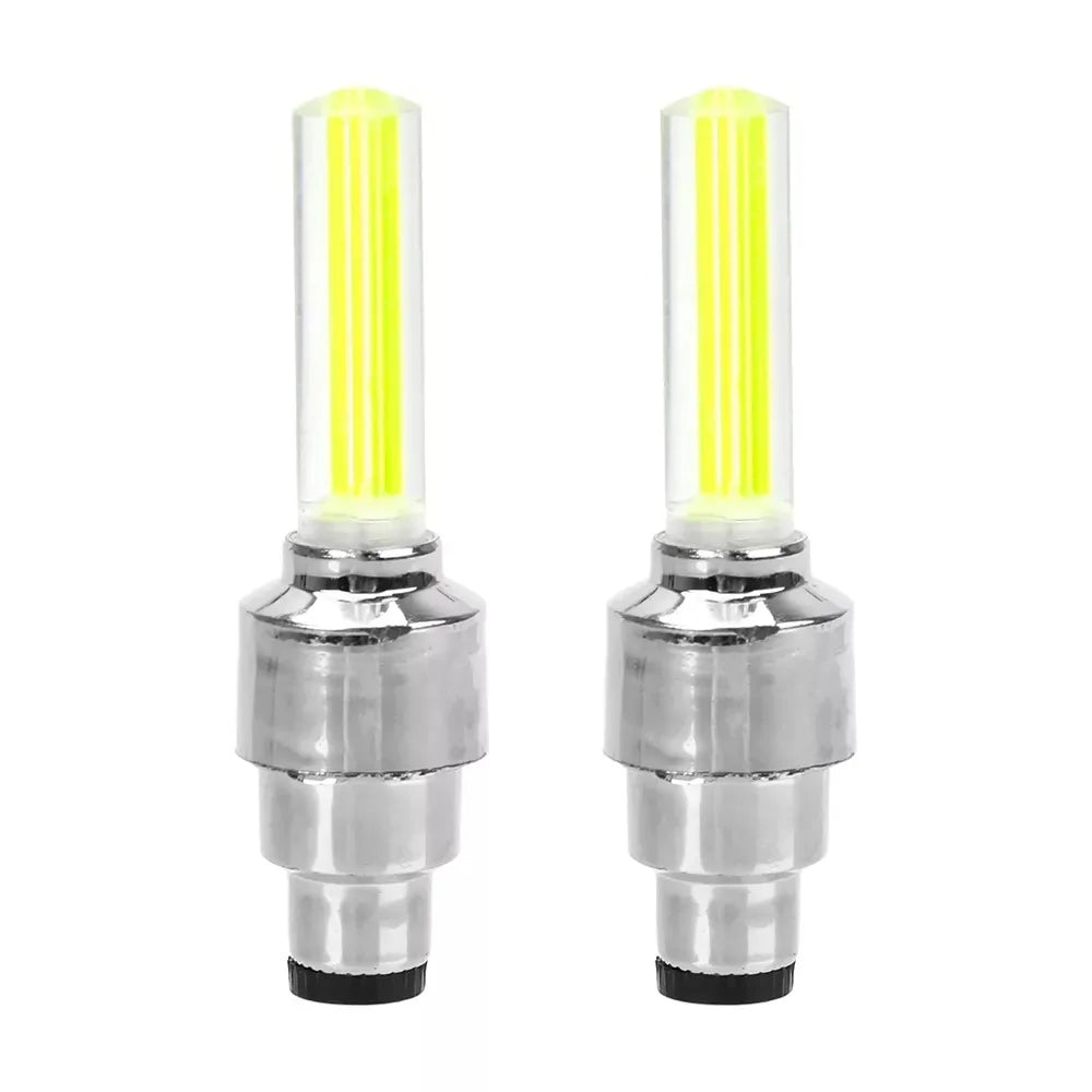 Decorative chrome tire valve caps with yellow LED lights for cars, motorcycles, or bicycles. Cycling warning flashlight lamps attached to the valve stems.