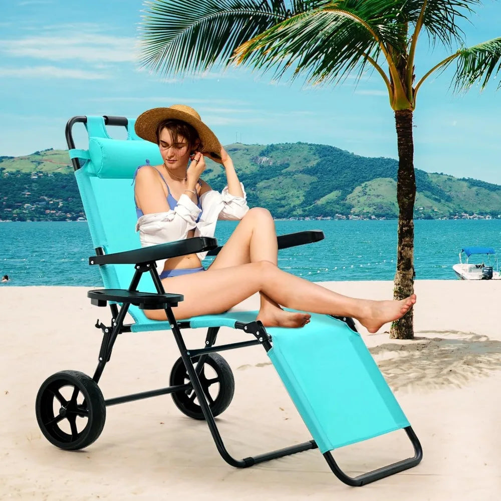 Folding beach chair with wheels, foldable backrest and footrest, placed on sandy beach with palm tree in the background