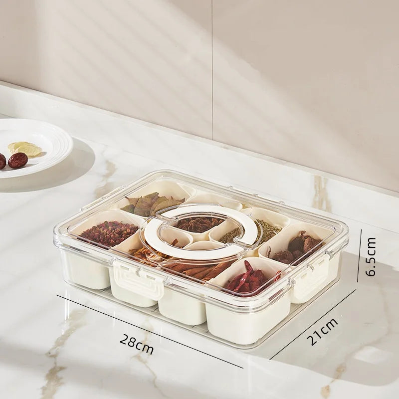 Divided compartment storage container for kitchen organization, holding various snacks and food items.